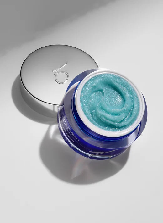 Blue cream in a jar with a silver lid on a light gray background